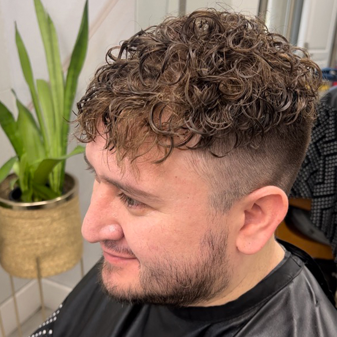 Finished curly men's hair system result at Faded By the Queen